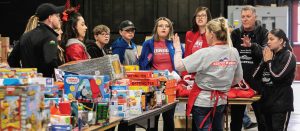 Volunteers prepare for the Mission’s toy giveaway last year.